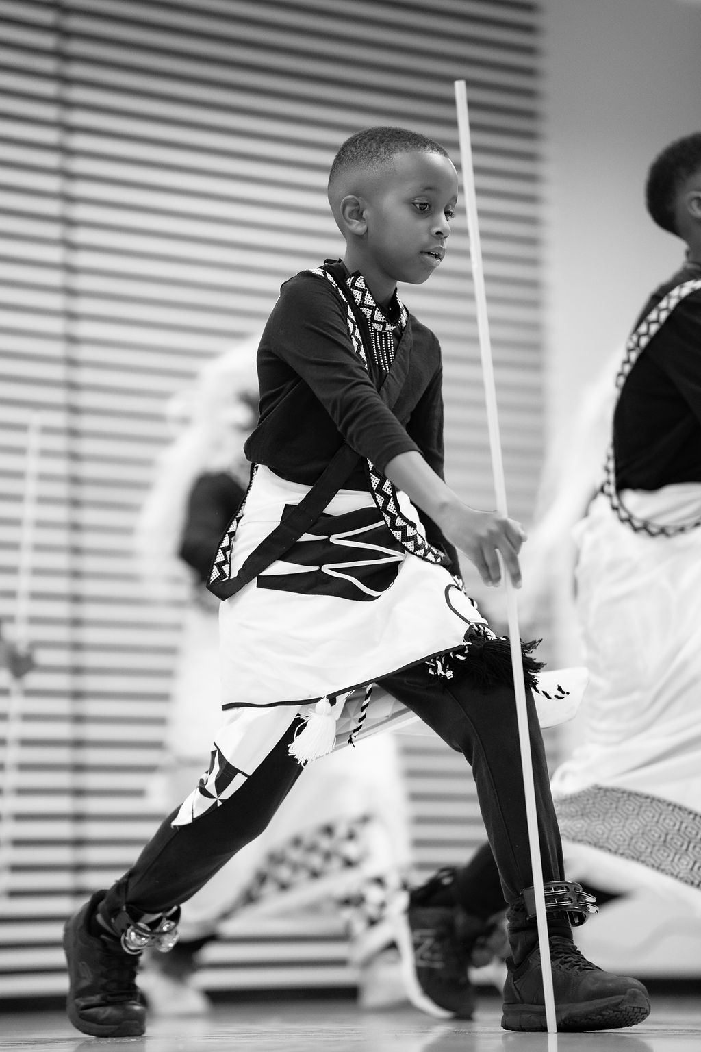 Youth performing traditional dance with group